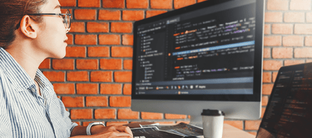 young woman viewing computer code on screen